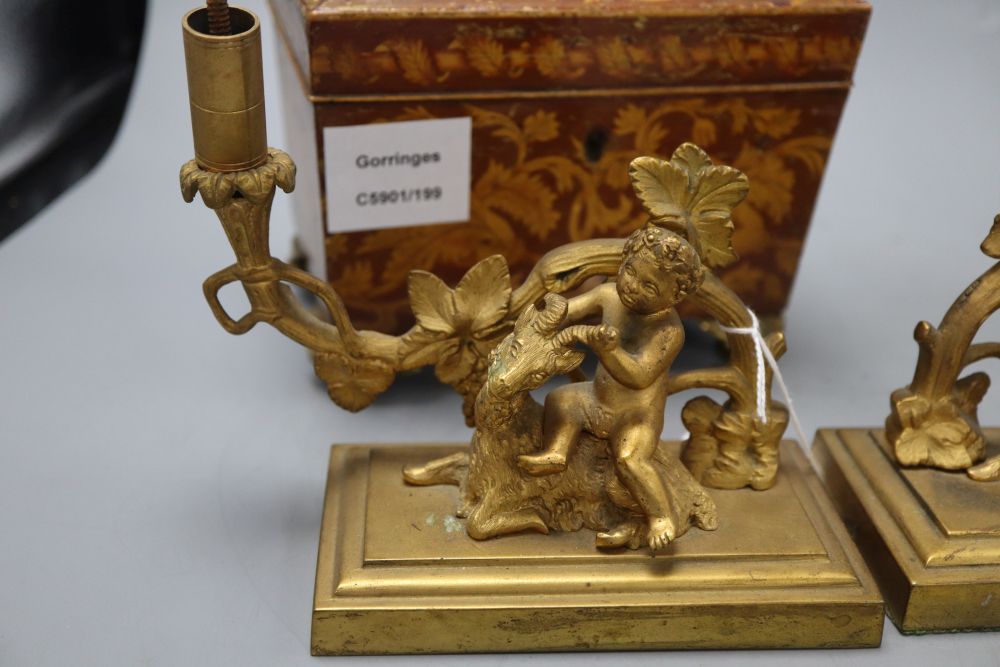 A William IV penwork tea caddy, a pair of ormolu Bacchanalian cherub candlesticks, lacking sconces and a hardwood dish stand